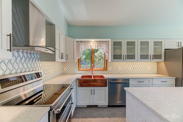 2685 Pinkerton Dr, East Helena, MT 59635 - kitchen featuring wall chimney exhaust hood, appliances with stainless steel finishes, a sink, and tasteful backsplash