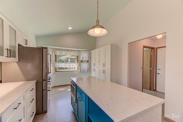 2685 Pinkerton Dr, East Helena, MT 59635 - kitchen with vaulted ceiling, white cabinetry, a kitchen island, stainless steel appliances, and blue cabinets