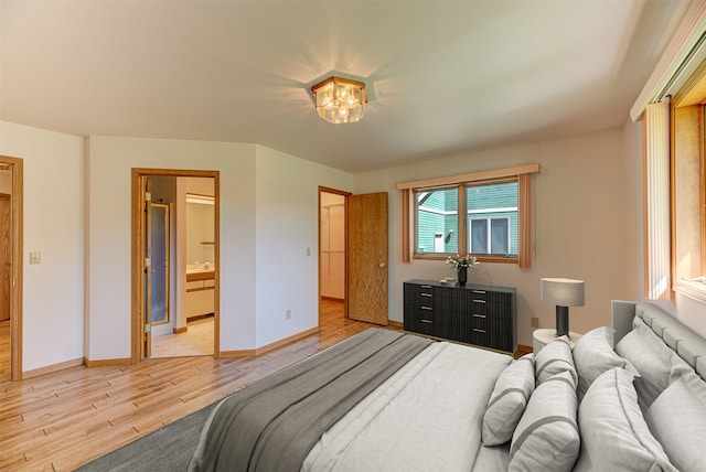 2685 Pinkerton Dr, East Helena, MT 59635 - bedroom featuring light wood-style flooring, baseboards, and ensuite bath