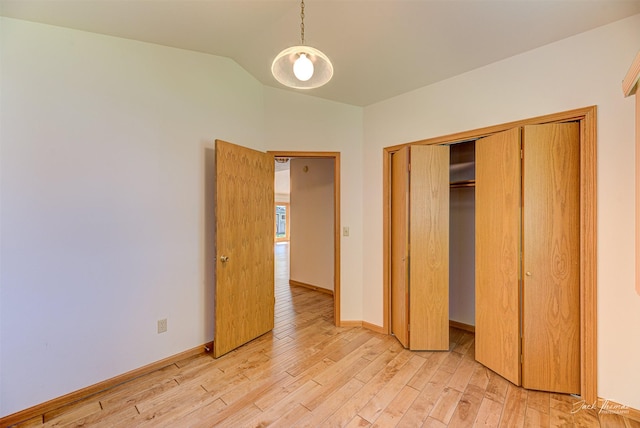 2685 Pinkerton Dr, East Helena, MT 59635 - unfurnished bedroom with light wood-style flooring, vaulted ceiling, a closet, and baseboards