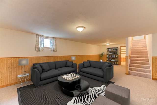 2685 Pinkerton Dr, East Helena, MT 59635 - carpeted living room with a wainscoted wall, stairs, wood walls, and a textured ceiling
