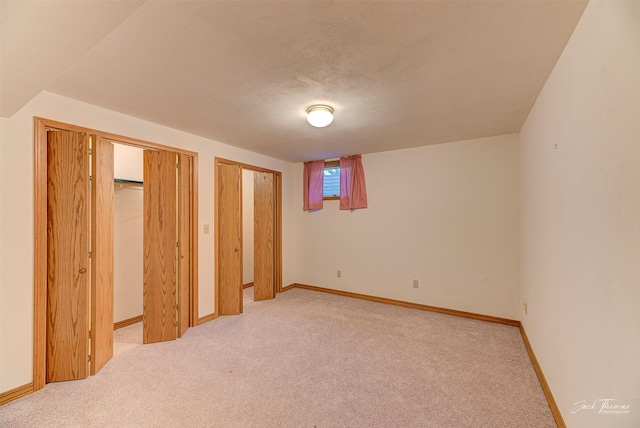 2685 Pinkerton Dr, East Helena, MT 59635 - unfurnished bedroom with multiple closets, light colored carpet, and baseboards
