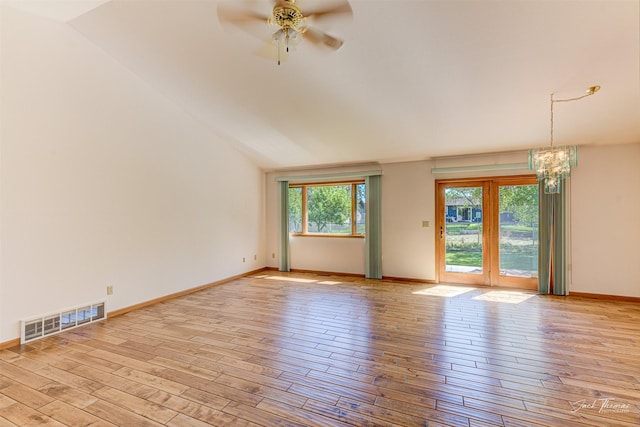 2685 Pinkerton Dr, East Helena, MT 59635 - spare room with a chandelier, wood finished floors, ceiling fan, baseboards, and lofted ceiling
