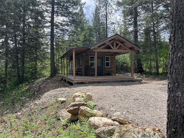 367 Lower River Rd, Heron, MT 59844 - view of front of house featuring a porch and a wooded view