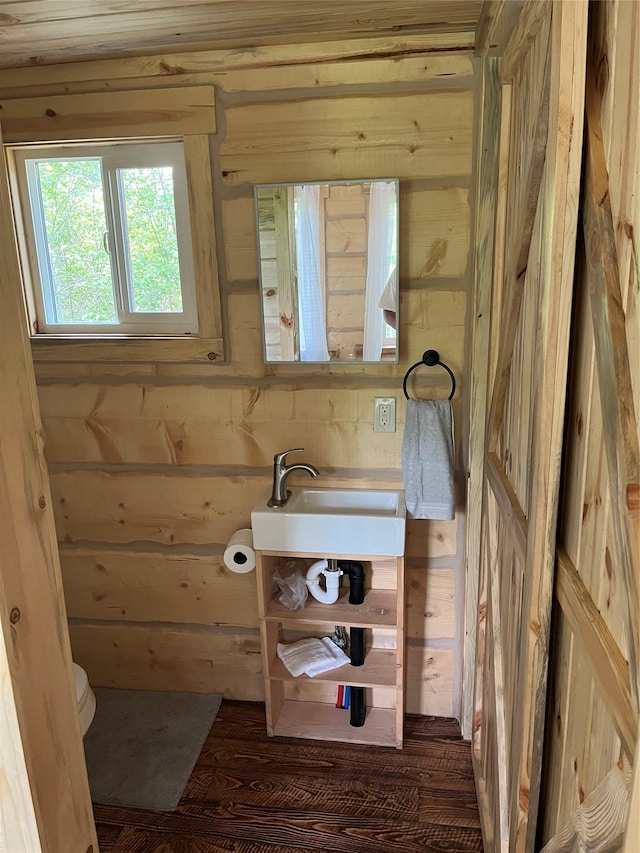 367 Lower River Rd, Heron, MT 59844 - half bath with wooden walls, toilet, and a sink