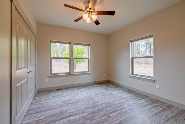 3525 Overland Rd, Helena, MT 59602 - unfurnished bedroom with multiple windows, wood finished floors, baseboards, and a closet