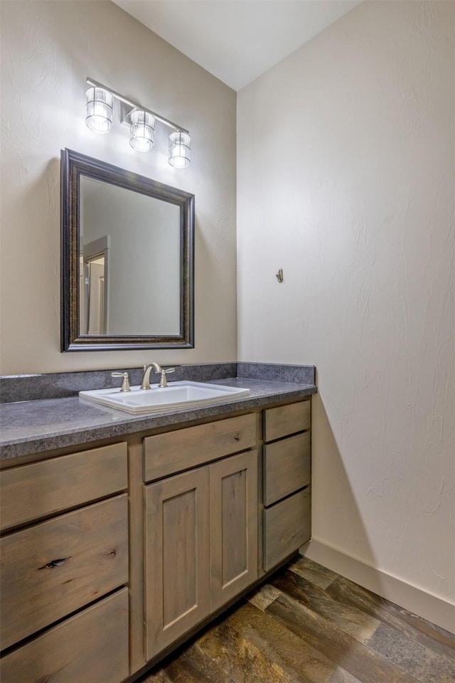 3525 Overland Rd, Helena, MT 59602 - bathroom with wood finished floors, vanity, and baseboards