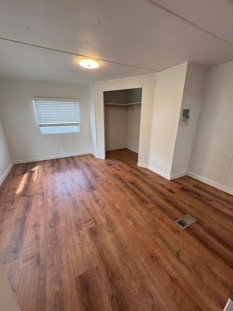 15291 Mullan Rd, Missoula, MT 59808 - unfurnished bedroom with wood finished floors, a closet, and baseboards