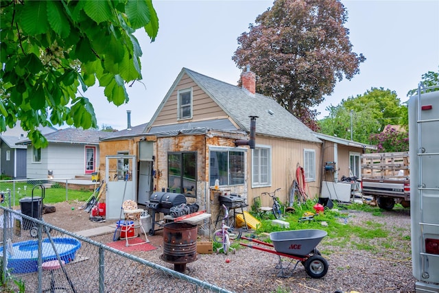 945 3rd Ave W, Kalispell, MT 59901 - rear view of property featuring a chimney and a shingled roof