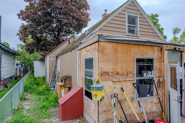 945 3rd Ave W, Kalispell, MT 59901 - view of home's exterior with a fenced backyard and a chimney