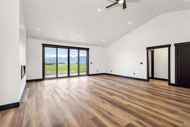 34544 Eagle Crest Dr, Polson, MT 59860 - empty room featuring ceiling fan, light wood-style floors, baseboards, high vaulted ceiling, and recessed lighting