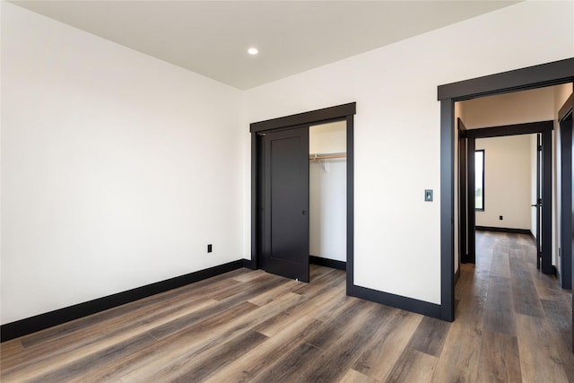 34544 Eagle Crest Dr, Polson, MT 59860 - unfurnished bedroom featuring wood finished floors, baseboards, recessed lighting, and a closet