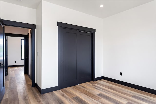 34544 Eagle Crest Dr, Polson, MT 59860 - unfurnished bedroom featuring wood finished floors, baseboards, recessed lighting, and a closet