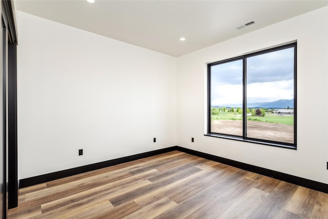 34544 Eagle Crest Dr, Polson, MT 59860 - empty room featuring light wood-type flooring, recessed lighting, baseboards, and a mountain view