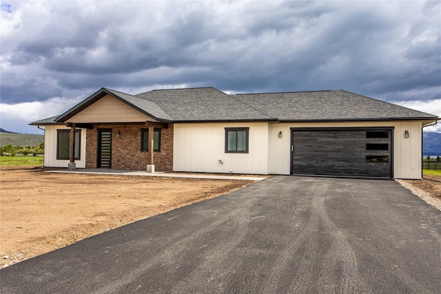 34544 Eagle Crest Dr, Polson, MT 59860 - view of front of home featuring driveway, an attached garage, and a shingled roof