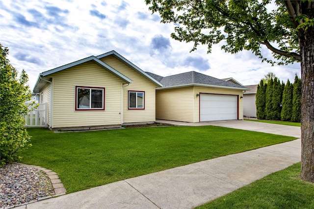 173 Empire Loop, Kalispell, MT 59901 - view of front of house featuring concrete driveway, an attached garage, a front yard, and a shingled roof