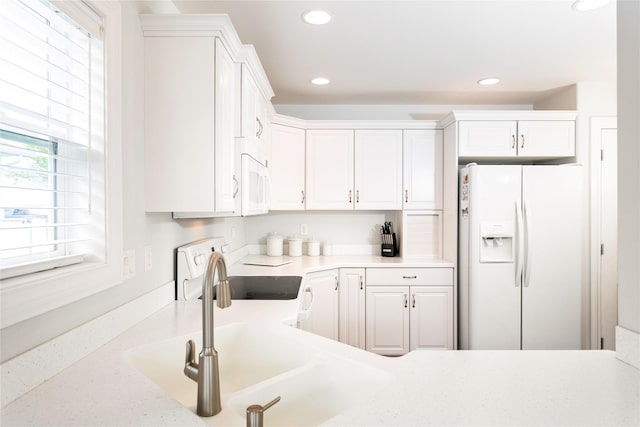 173 Empire Loop, Kalispell, MT 59901 - kitchen featuring white appliances, white cabinetry, light countertops, and recessed lighting