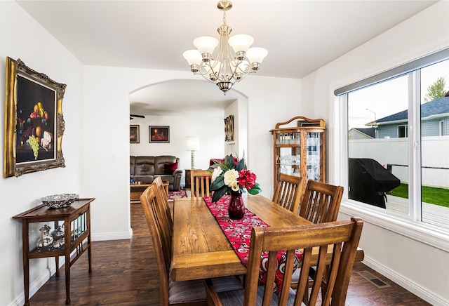 173 Empire Loop, Kalispell, MT 59901 - dining room with arched walkways, dark wood finished floors, baseboards, and a chandelier