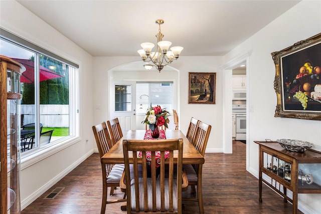 173 Empire Loop, Kalispell, MT 59901 - dining room with a chandelier, plenty of natural light, wood finished floors, and baseboards