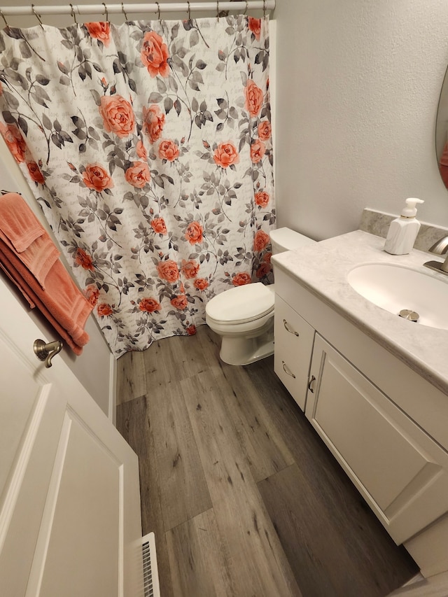 173 Empire Loop, Kalispell, MT 59901 - full bath featuring wood finished floors, vanity, toilet, and curtained shower