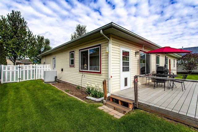 173 Empire Loop, Kalispell, MT 59901 - view of property exterior featuring a deck, outdoor dining area, and central AC