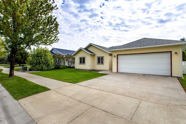 173 Empire Loop, Kalispell, MT 59901 - ranch-style home with driveway, a front lawn, and an attached garage