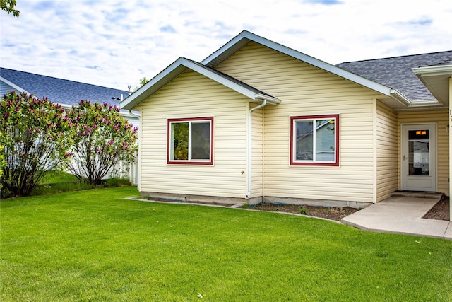 173 Empire Loop, Kalispell, MT 59901 - rear view of house featuring a yard and roof with shingles