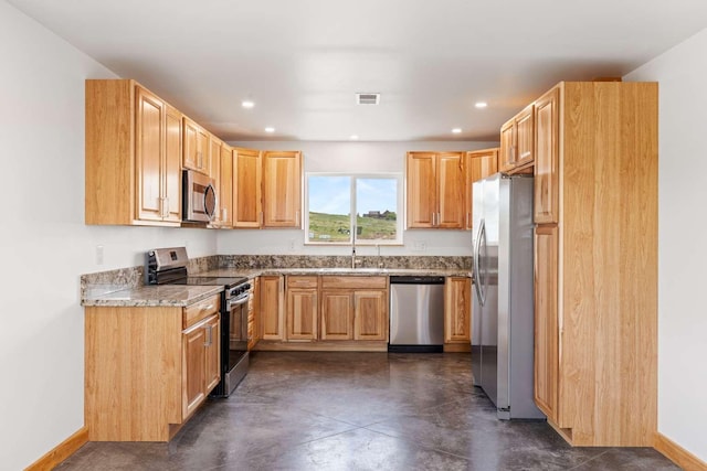 28 Mackenzie Mountain Way, Three Forks, MT 59752 - kitchen featuring appliances with stainless steel finishes, finished concrete floors, recessed lighting, baseboards, and a sink