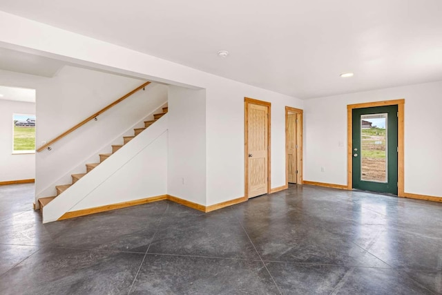 28 Mackenzie Mountain Way, Three Forks, MT 59752 - spare room featuring plenty of natural light, baseboards, concrete floors, and recessed lighting