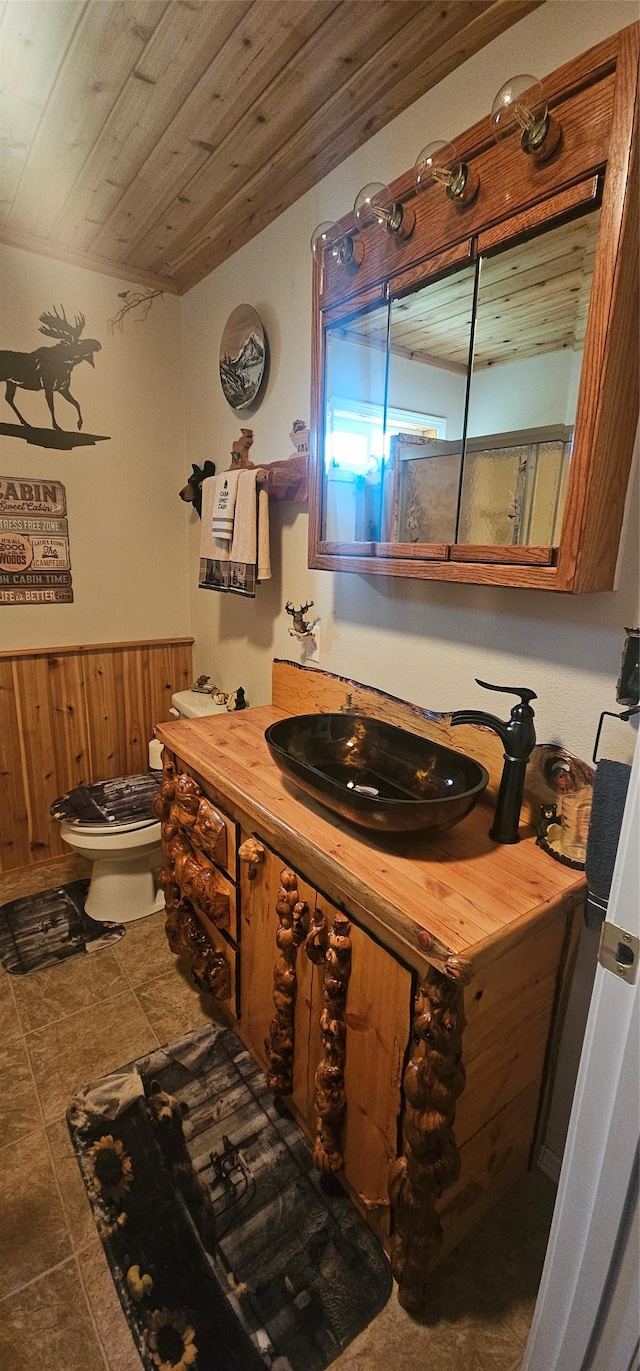 194 Whitetail Dr, Haugan, MT 59842 - bathroom with toilet, vanity, tile patterned floors, and wooden ceiling