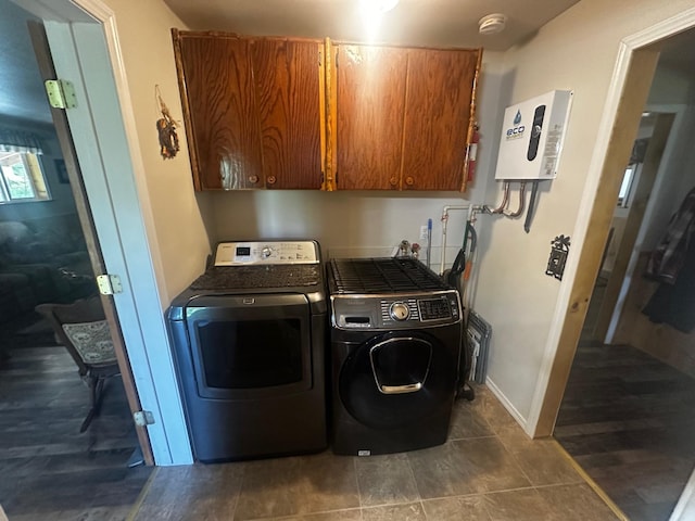 194 Whitetail Dr, Haugan, MT 59842 - washroom featuring cabinet space, independent washer and dryer, radiator heating unit, dark tile patterned flooring, and water heater
