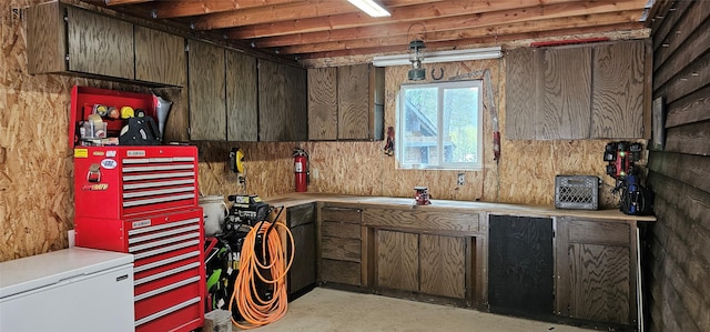 194 Whitetail Dr, Haugan, MT 59842 - kitchen with light countertops, fridge, and concrete flooring