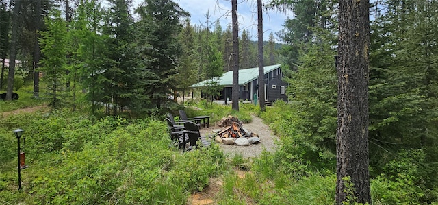 194 Whitetail Dr, Haugan, MT 59842 - view of yard with an outdoor fire pit and a view of trees