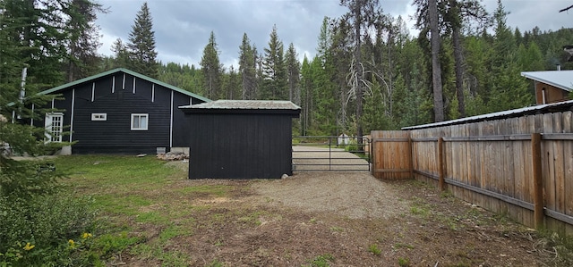 194 Whitetail Dr, Haugan, MT 59842 - view of home's exterior featuring a gate and a forest view