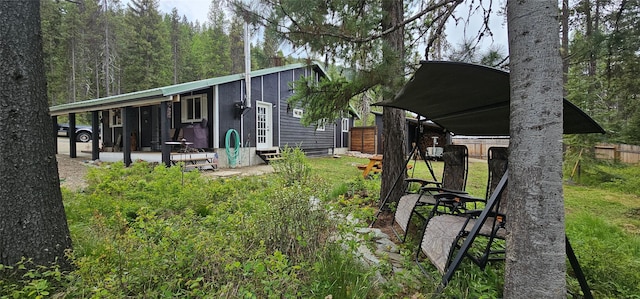 194 Whitetail Dr, Haugan, MT 59842 - rear view of property featuring entry steps and a wooded view