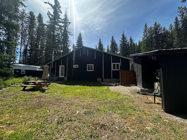 194 Whitetail Dr, Haugan, MT 59842 - rear view of property featuring a lawn