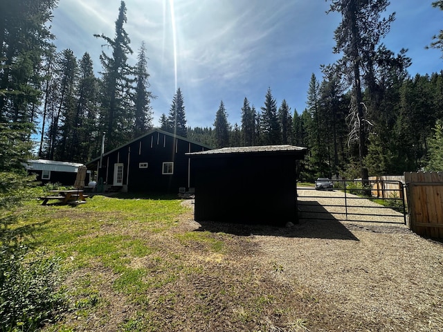194 Whitetail Dr, Haugan, MT 59842 - view of outbuilding featuring a gate and a forest view