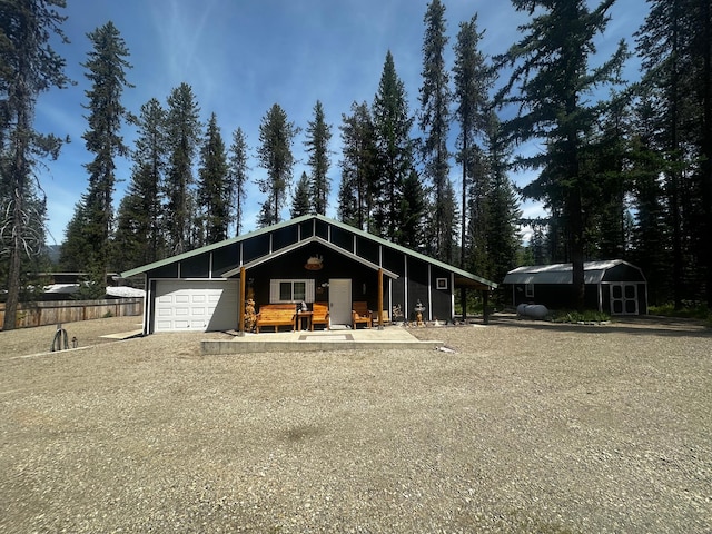 194 Whitetail Dr, Haugan, MT 59842 - view of front of house with a garage, an outbuilding, and driveway
