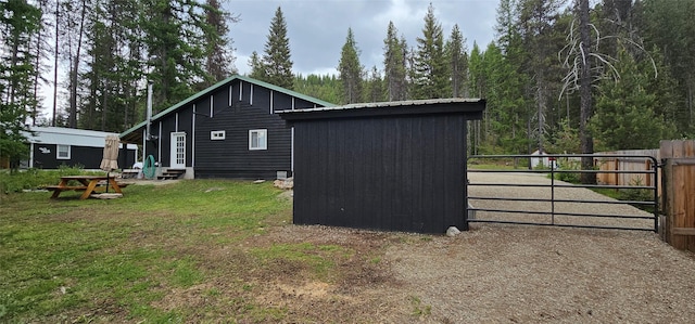 194 Whitetail Dr, Haugan, MT 59842 - view of side of property with entry steps, a gate, and a forest view