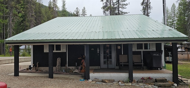 194 Whitetail Dr, Haugan, MT 59842 - back of house featuring covered porch and metal roof