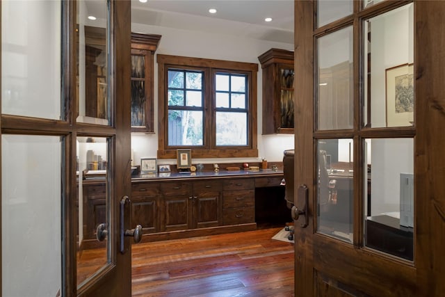 237 Harbor Dr, Bigfork, MT 59911 - kitchen with dark wood-style floors, glass insert cabinets, dark brown cabinetry, recessed lighting, and dark countertops