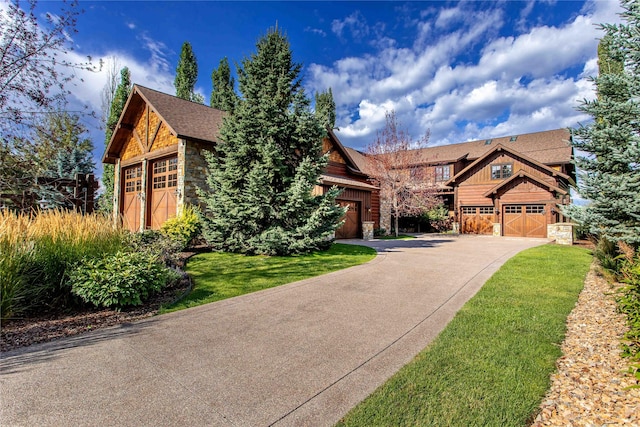 237 Harbor Dr, Bigfork, MT 59911 - craftsman-style home featuring stone siding, driveway, and board and batten siding