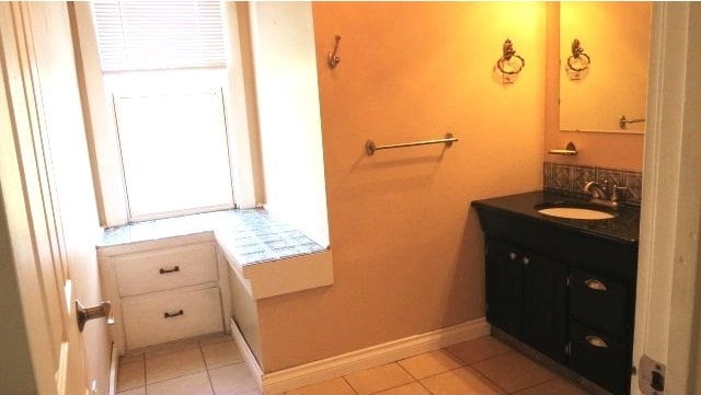 726 4th Ave S, Great Falls, MT 59405 - bathroom featuring vanity, tile patterned floors, and baseboards