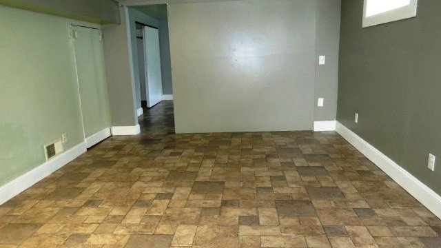 726 4th Ave S, Great Falls, MT 59405 - spare room with baseboards and brick patterned flooring
