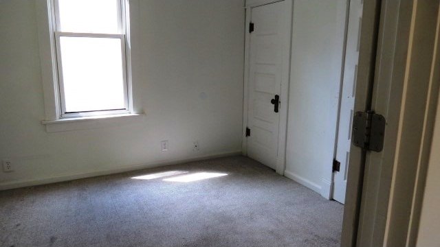 726 4th Ave S, Great Falls, MT 59405 - unfurnished bedroom with light colored carpet and baseboards