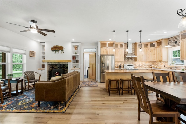 11501 Sleeman Creek Rd, Lolo, MT 59847 - living room featuring light wood-style flooring, ceiling fan, a fireplace, and recessed lighting