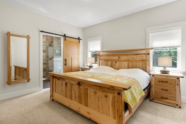 11501 Sleeman Creek Rd, Lolo, MT 59847 - bedroom with light carpet, a barn door, and connected bathroom