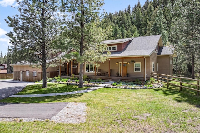 11501 Sleeman Creek Rd, Lolo, MT 59847 - view of front of house featuring a shingled roof and covered porch