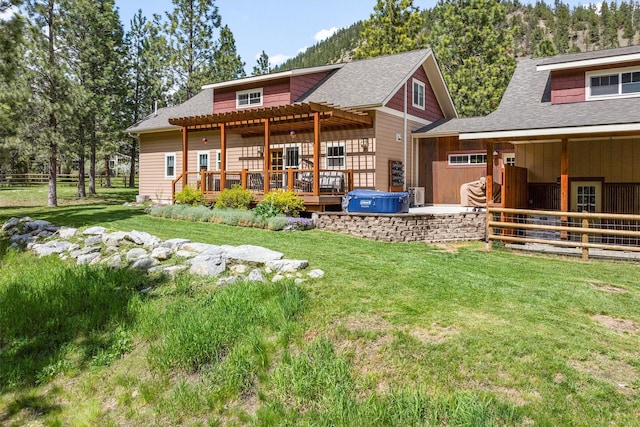 11501 Sleeman Creek Rd, Lolo, MT 59847 - back of property featuring a pergola, a shingled roof, a deck, and an exterior structure