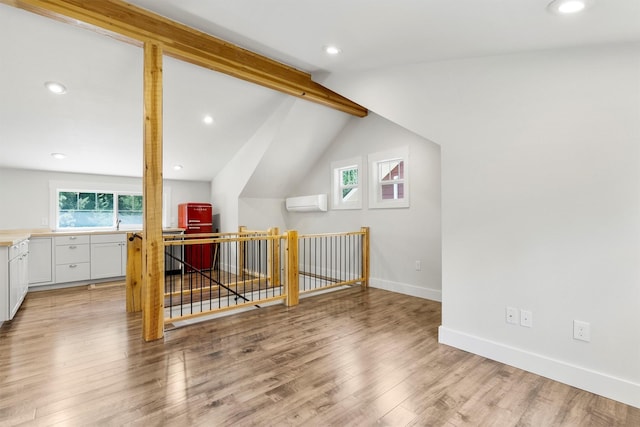 11501 Sleeman Creek Rd, Lolo, MT 59847 - additional living space with light wood finished floors, a wall mounted air conditioner, and recessed lighting